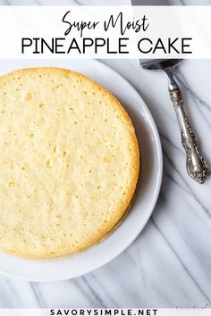 a cake sitting on top of a white plate next to a knife and fork,