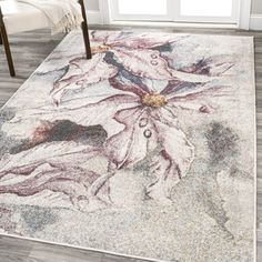 a white rug with flowers on it