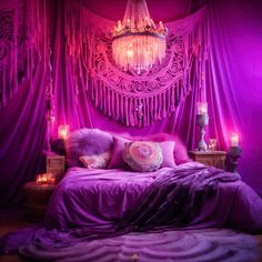 a bed with purple sheets and pillows in front of a chandelier filled with candles