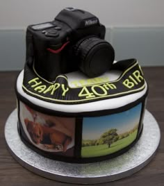 a birthday cake decorated with pictures and a camera