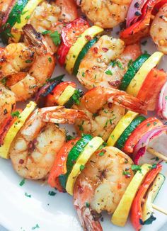 grilled shrimp and vegetable kabobs on a white plate