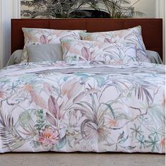 an image of a bedroom setting with flowers on the comforter and bedding set