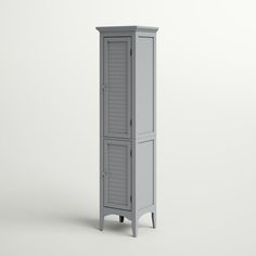 a tall gray cabinet with shutters on the front and bottom, against a white background