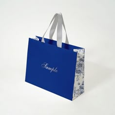 a blue shopping bag with the word simply on it's front and white handles