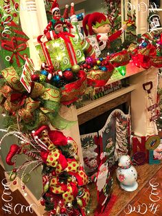 a fireplace decorated for christmas with stockings and ornaments