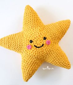 a crocheted yellow starfish with pink eyes