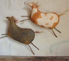 two sculptures of animals are on the wall