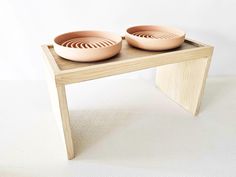 two bowls sitting on top of a wooden table