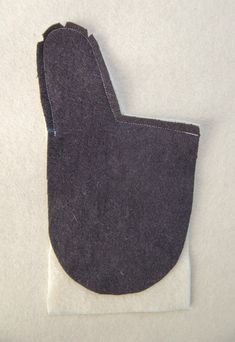 a piece of felt that has been sewn on and is sitting on a white surface