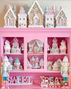 a pink hutch filled with lots of little houses