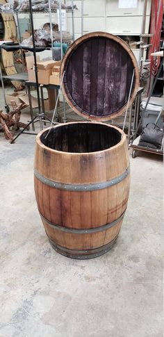 a wooden barrel sitting on top of a cement floor