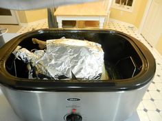 a toaster with foil wrapped in aluminum foil