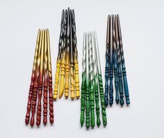 several different colored crochet hooks on a white surface