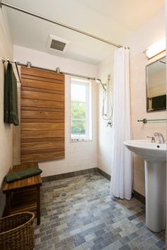 a bathroom with a sink, mirror and shower