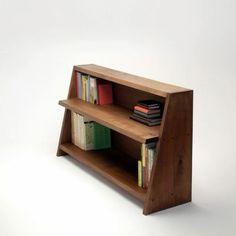 a wooden shelf with books on it and some other items in the bottom half of it