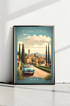 a blue car is parked in front of a white wall with the words toscana on it