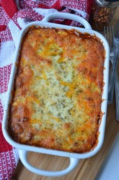 a casserole dish with cheese and broccoli in it on a table