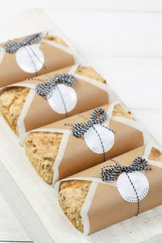 four pieces of bread wrapped in brown paper and tied with twine on top of each other