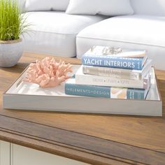 a wooden table topped with books and a plant