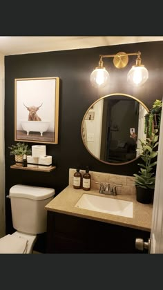 a bathroom with a toilet, sink and mirror in it's centerpieces