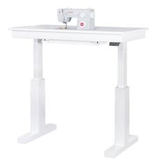 a sewing machine sitting on top of a white table with two legs and a foot rest