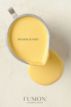 a yellow paint in a metal pan with the words fuson painted on it's side