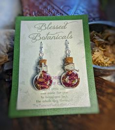 a pair of earrings sitting on top of a card