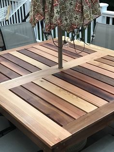 a wooden table with an umbrella over it