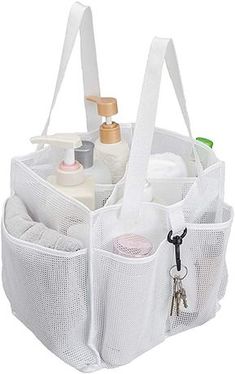 a white mesh bag filled with lots of bottles and other personal care items in it