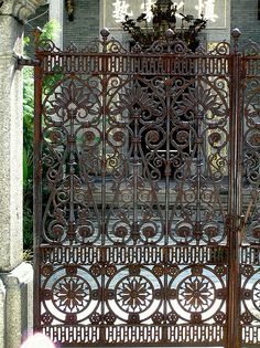 an ornate iron gate in front of a building