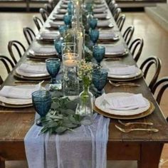 the table is set with place settings, plates and napkins for dinner guests to enjoy