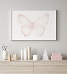 a pink butterfly is hanging on the wall above a dresser