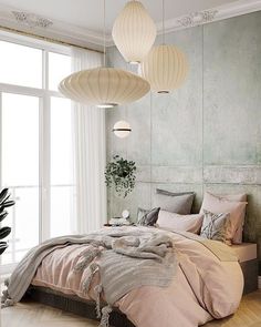 a bedroom with two lamps hanging from the ceiling