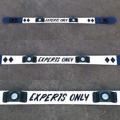 three black and white skis with the words experts only written on them are shown