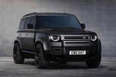 an suv is parked in front of a mountain