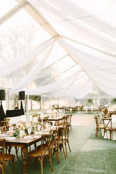 tables and chairs are set up under a tent