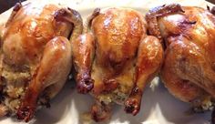 three pieces of chicken sitting on top of a white plate