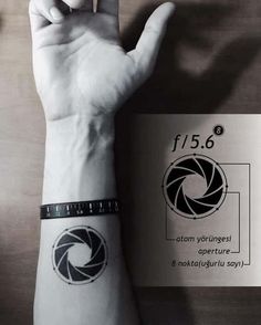 a person with a wrist tattoo holding up their hand