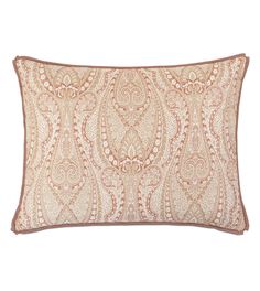 an orange and pink paisley pillow on a white background