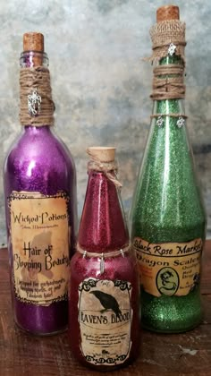 three bottles with different colored liquids in them