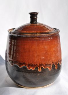 a brown and black pot sitting on top of a table