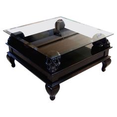 a coffee table with a glass top on wheels