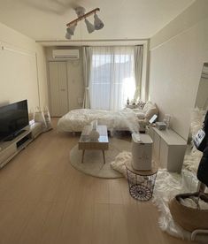 a living room filled with furniture and a flat screen tv