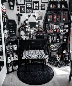 a room filled with lots of black and white decor on the walls, including a desk