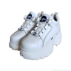 Elevate Your Active And Casual Wear With These Buffalo London Classic Sneaker Trainers Low. These Shoes Come In A Stylish White Color With Accents Of Lace, Eyelet, And Logo That Add A Touch Of Uniqueness To Your Outfit. The Shoes Are Made Of A Blended Fabric Of Leather And Synthetic Lining Material That Ensures Breathability And Comfort. These Sneakers Have A Low Top Shoe Shaft Style And A Standard Shoe Width That Fits Perfectly With A Us Shoe Size Of 9 And Uk Shoe Size Of 7. The Outsole Materia Buffalo Shoes, Buffalo London, Classic Sneakers, Top Shoes, Step Up, Low Top, White Color, Buffalo, Casual Wear