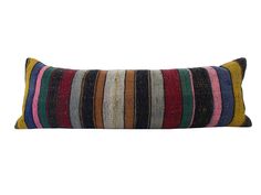 a multicolored striped pillow on a white background