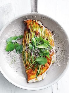 a white bowl filled with food on top of a table