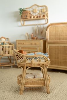 a wicker baby crib with pillows on it