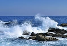 waves crashing on rocks in the ocean