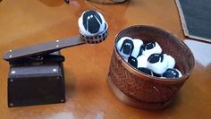 two cupcakes with black and white frosting in a basket on a table